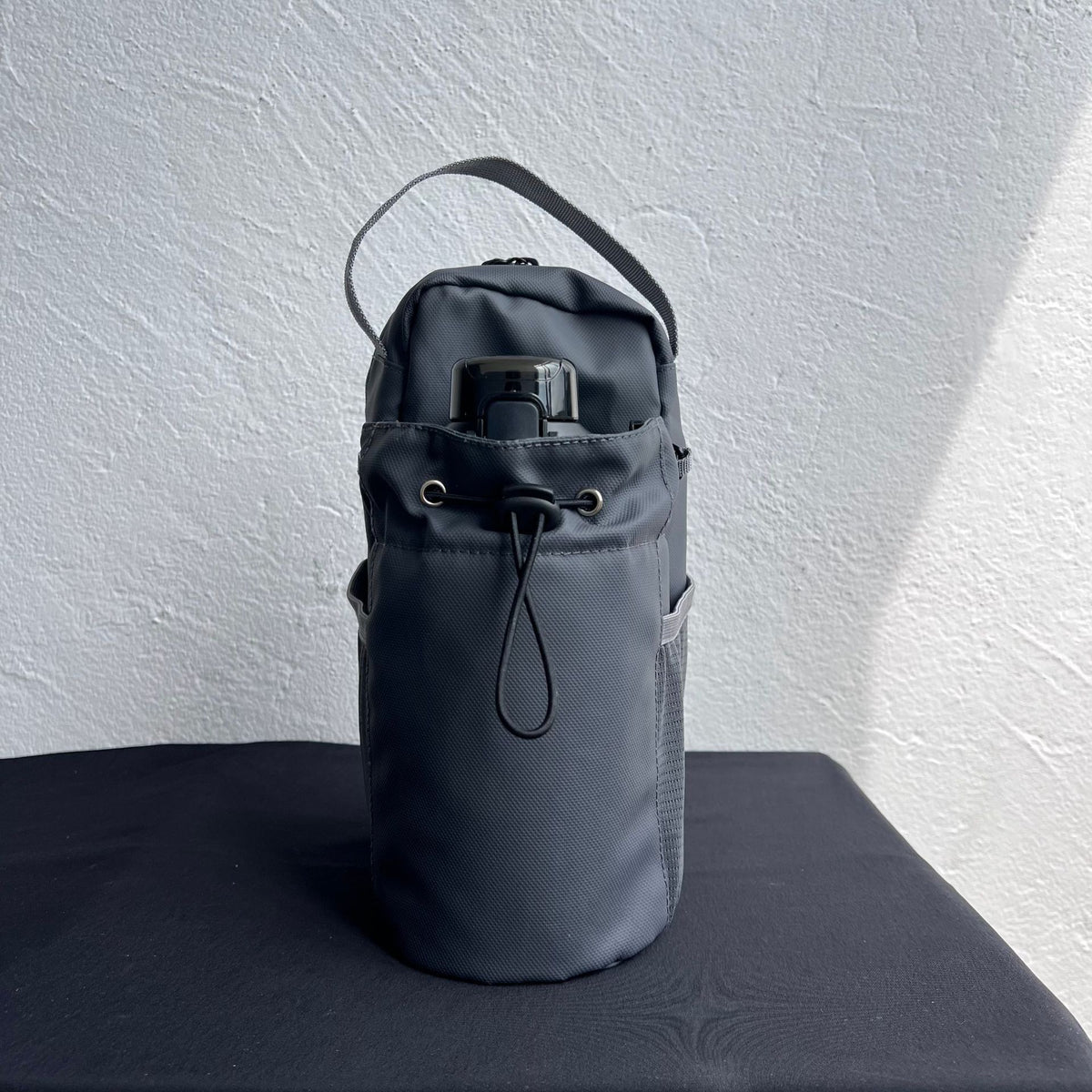Gray water bottle holder bag with front drawstring pocket
